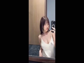 Akane27 in camisole reveals cleavage.