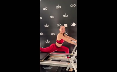 Dafne Keen fully clothed performing pilates exercises