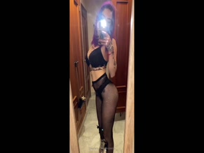 kleopwtrx in bra, panties, and fishnets poses in mirror