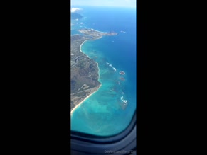 tiffany.753200:00 Aerial view of Hawaiian coastline during flight.