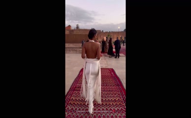 Maya Jama backless dress ass view