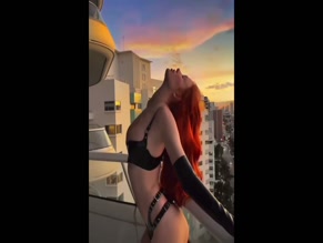 Angelina Michelle topless sunset balcony pose.