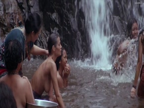 Charlotte Lewis bare breasts in jungle waterfall scene.