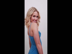 Blonde in blue dress twirls and smiles