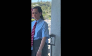 Mary Mouser getting ready for a shoot, schoolgirl outfit, and smiling