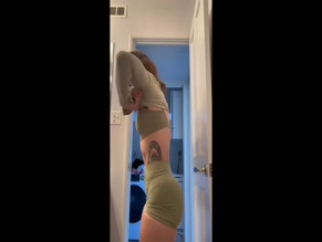 LeanBeefPatty shows off her abs and ass in a green workout outfit.