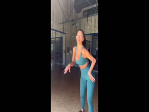 Nicole Scherzinger twerks in teal workout gear.
