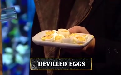 Holly Willoughby blindfolded, catching deviled eggs in mouth from tube