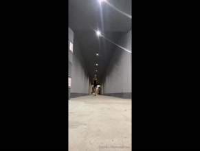 museforyou in a black dress squats in heels