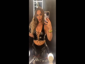 BOOTYQUEENBAE in leather top and skirt.