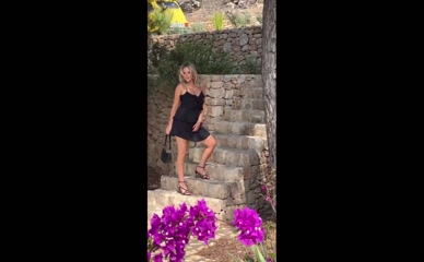 Emily Atack in a short black dress.