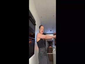 Daisy Campbell dances in a tank top.