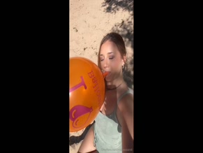 midwestandi blowing up a large orange balloon