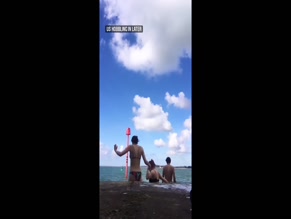Bikini-clad women jump into water